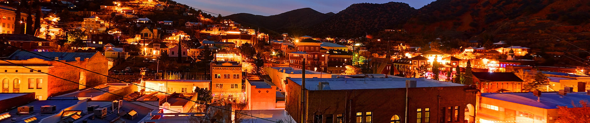 town at night with the mountains in the background