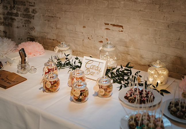 candy bar with cake pops and mason jars filled with candy