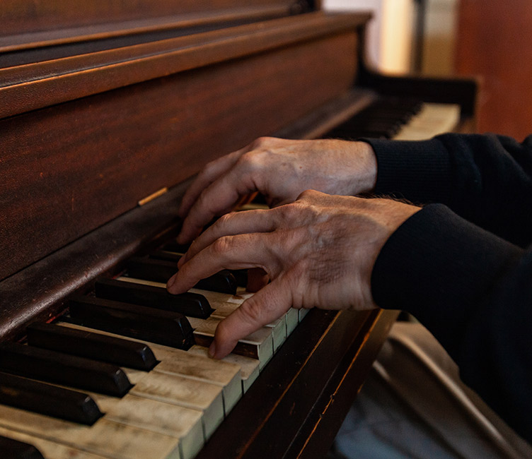 person playing on an aged piano
