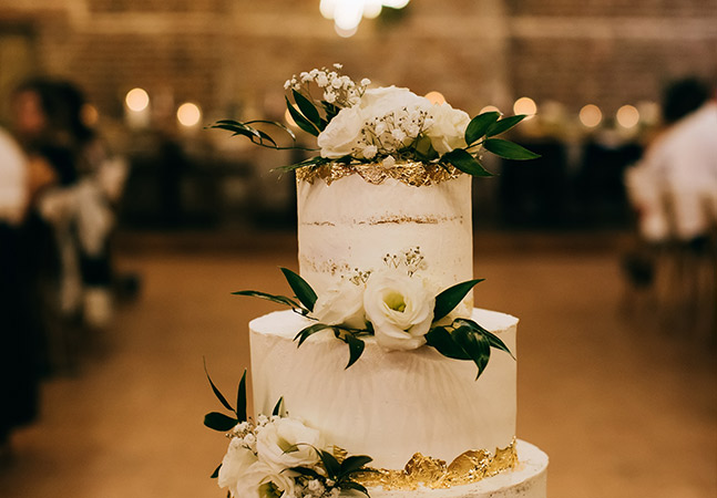 close up image of a beautiful wedding cake with gold accents