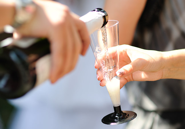 person pouring champagne in a glass