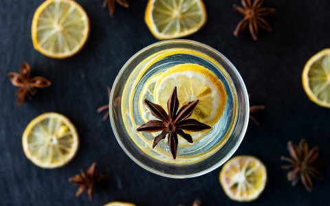 Top view of a tropical cocktail with some lemon slices 