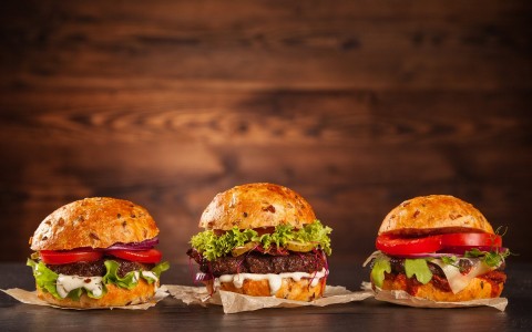 Front view of three tasty hamburgers 