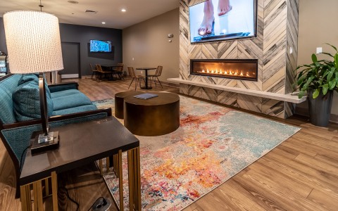 indoor sitting area with a fireplace and tv