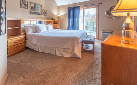 bedroom with a sliding glass door and blue curtains