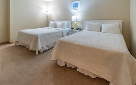 double bed bedroom with white comforters