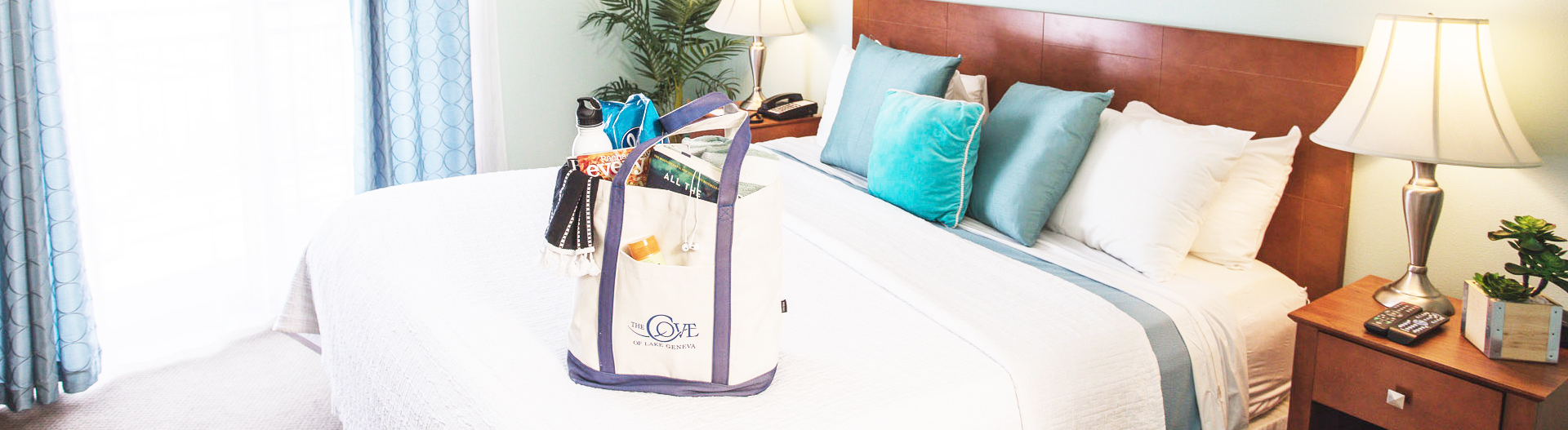 a beach bag on the bed inside a guest room