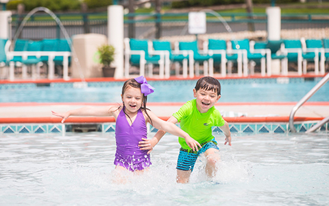 Two kids playing in a pool