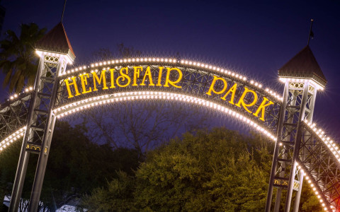 hemisfair park arch lit up with lights at night