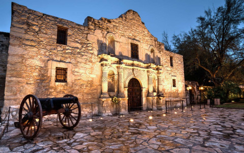 close up of the alamo with lights at night