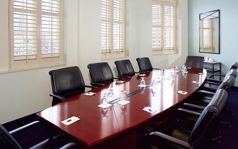 executive boardroom with black chairs and a conference table