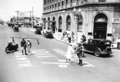 people filming a scene on a street