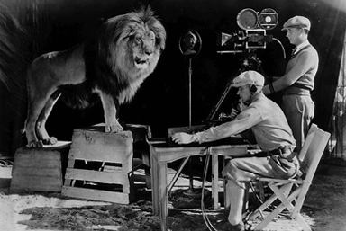 lion on set with 2 film producers
