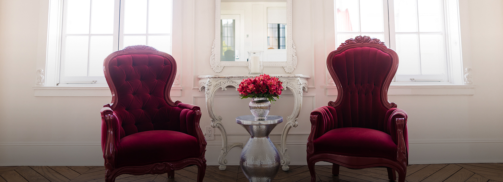 2 red chairs with flower vase in the middle