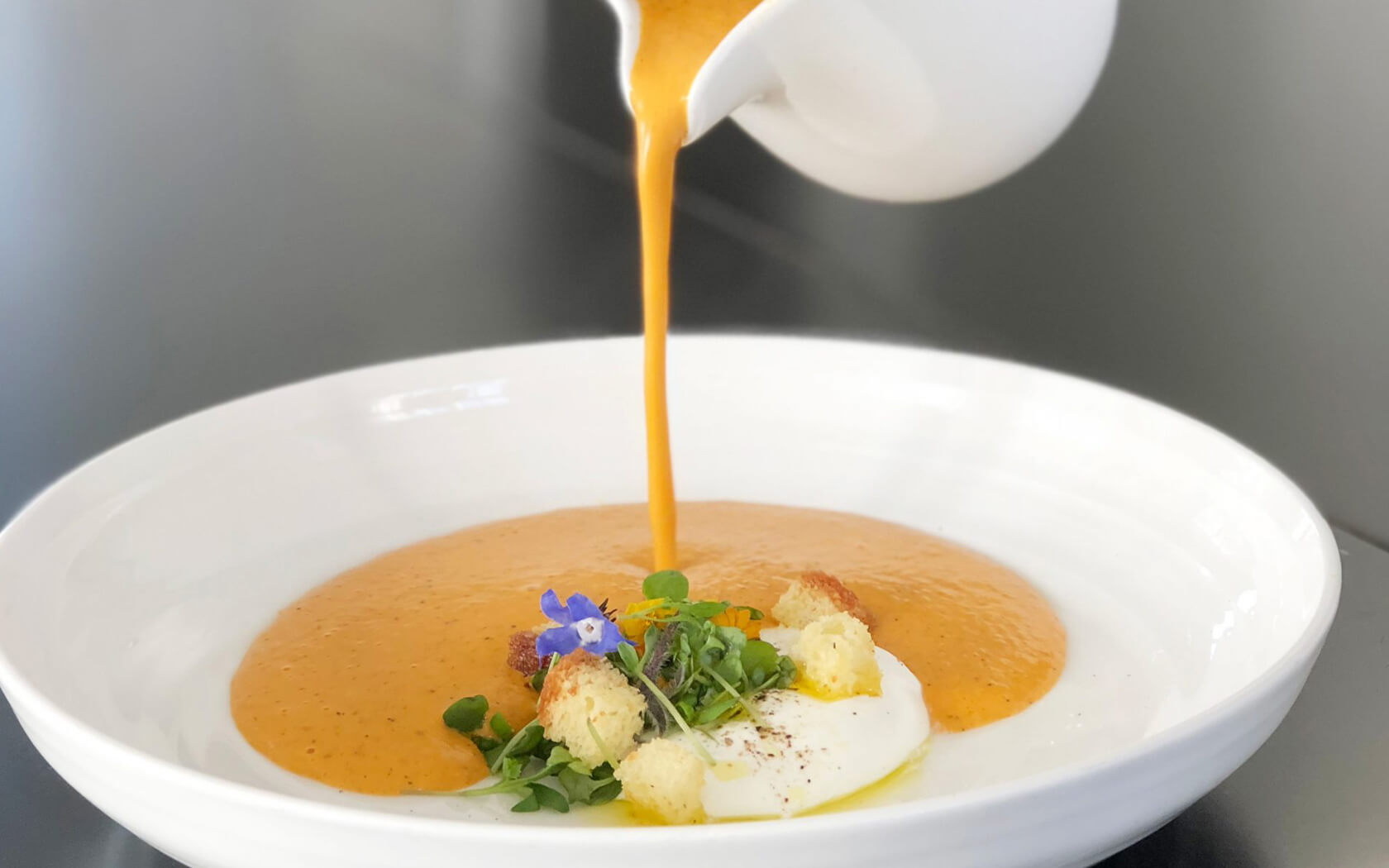 soup being poured into bowl