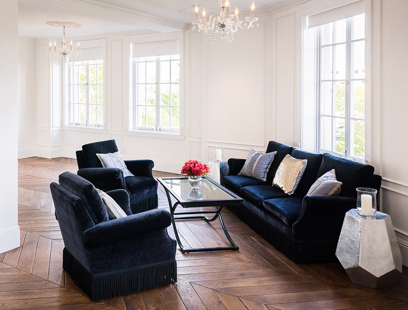 blue couches with glass table