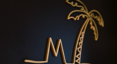 Logo with letter M and a palm tree