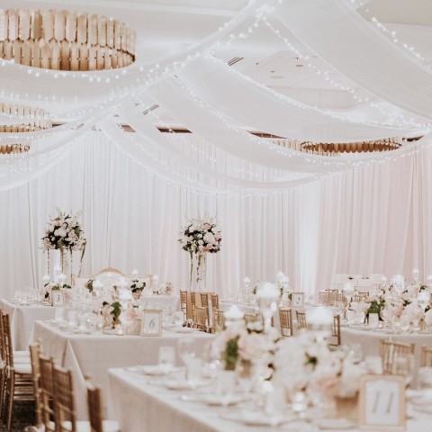 wedding reception area with white tapestries