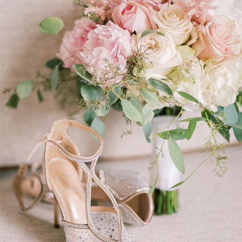 bride's jeweled heels next to pink bridal bouquet with roses and peonies