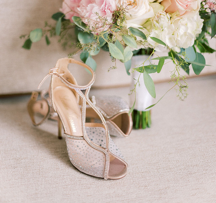 bride's shoes and pink bouquet