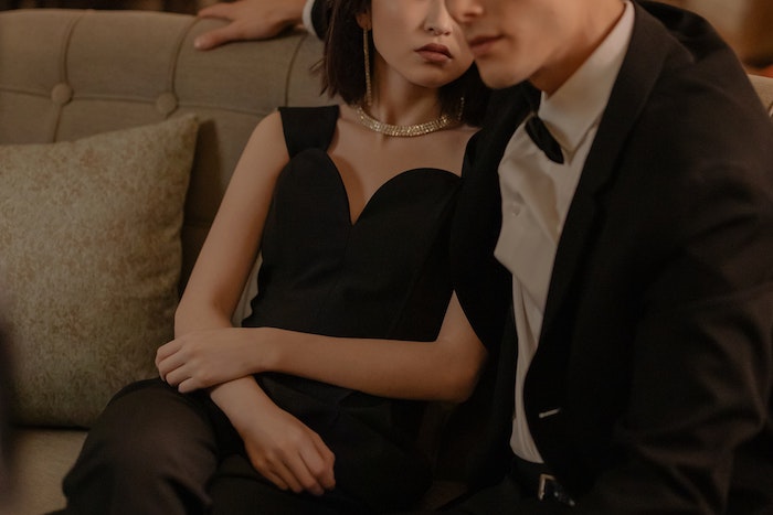 couple dressed up sitting on couch