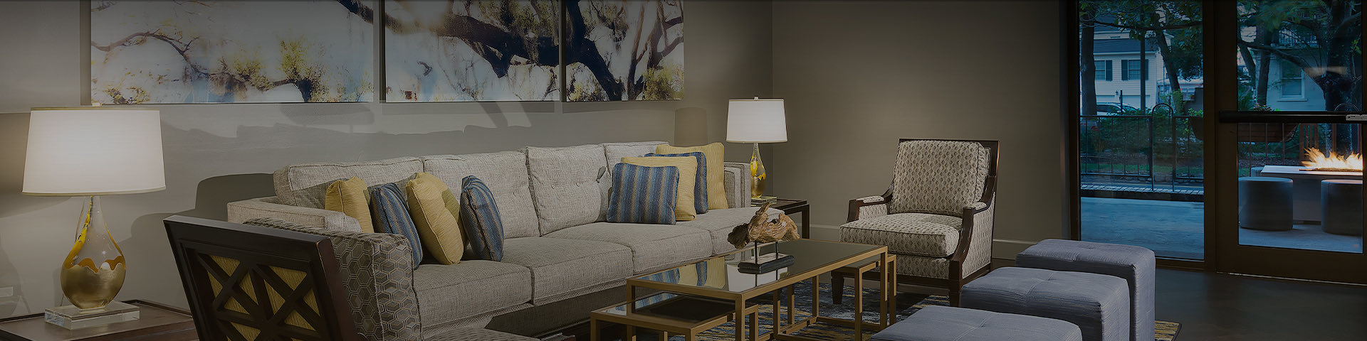 living room area with long couch and two chairs