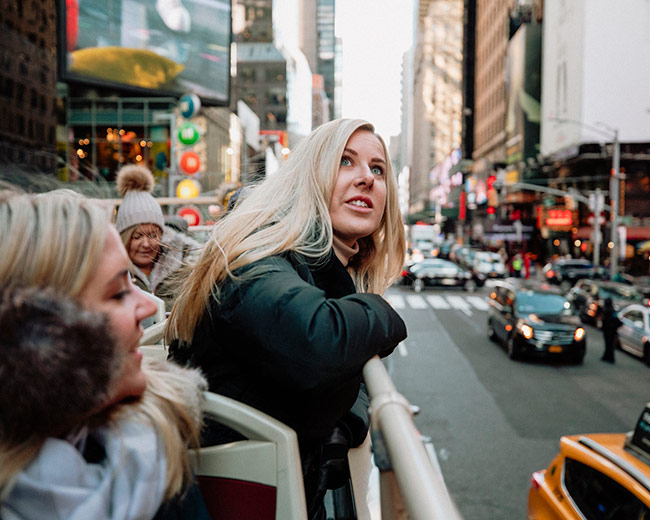 tourists in open roof bus in new york