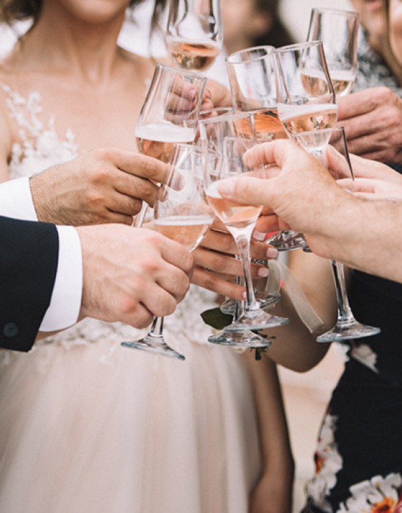 guests at a wedding clinking their glasses