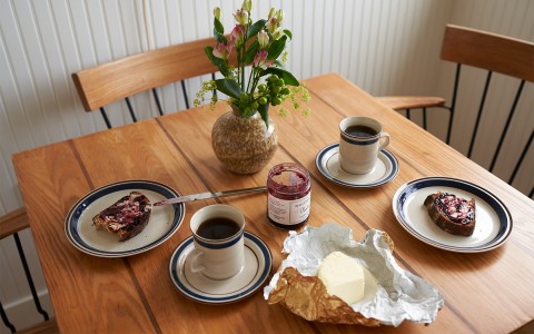 A wooden table with toast and coffee on it.