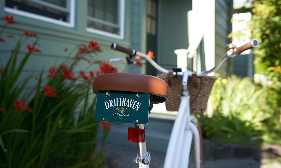 A close up of the back of a bicycle with a small drifthaven tag on the back of the seat.
