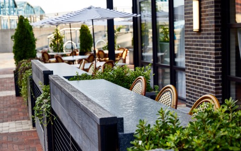 outdoor patio with patio furniture and umbrellas in the background