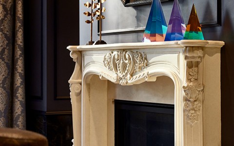 a white fireplace mantle with decorations and a mirror above it