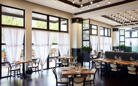 interior of a well lit restaurant with white walls and black accent color 