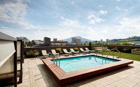 pool in the sun with a view of the mountains in the background
