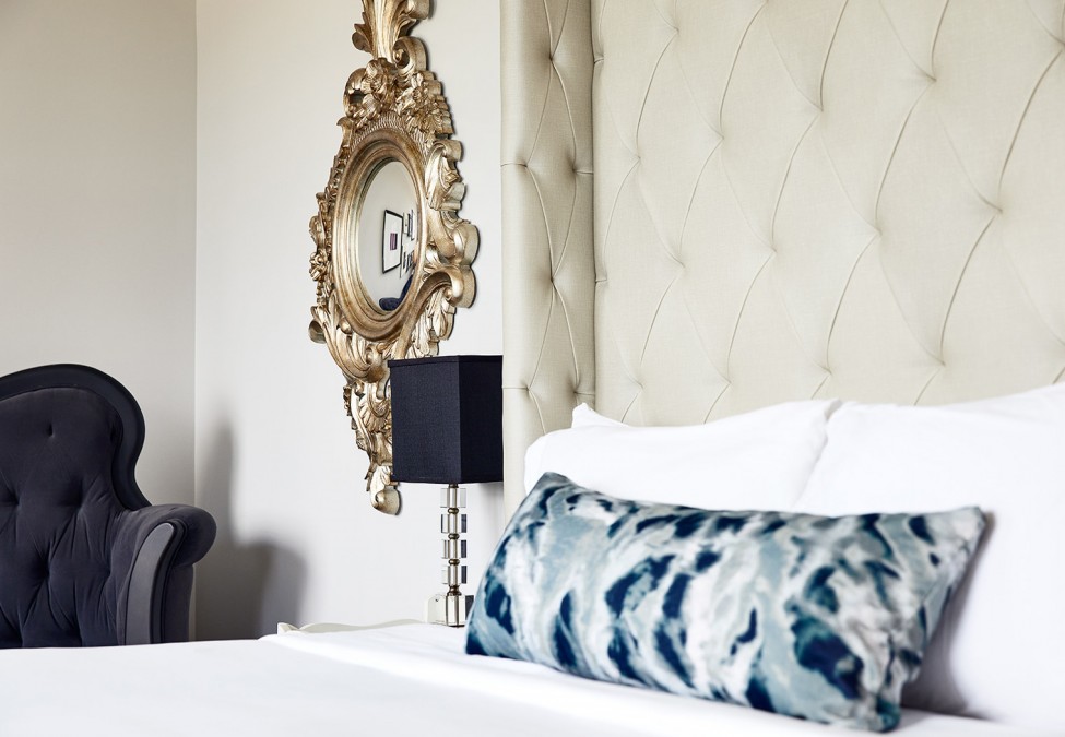 view of white linen bed and decor