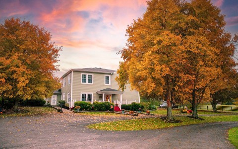 View of one of the properties surrounded by beautiful autumn trees on a sunset