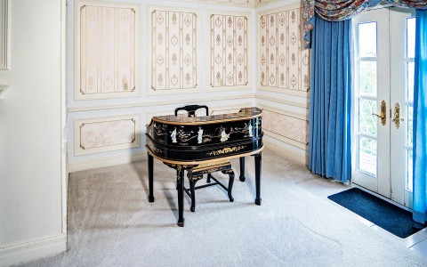 View of a little classic piano inside of a luxury room