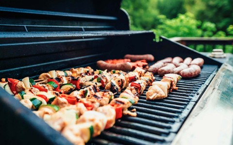 View of some chicken brochettes on a BBQ