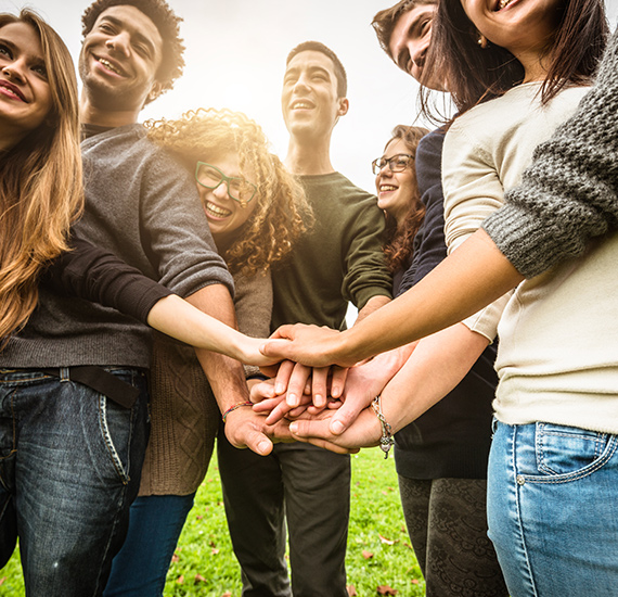 View of a diverse group of people holding hands