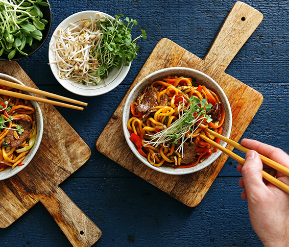 Overhead view of person eating with chopsticks
