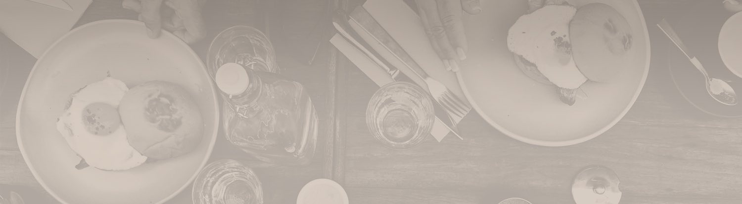 silverware and glass bottle on a wooden table