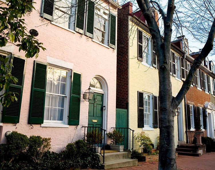 yellow and pink buildings lining side walk