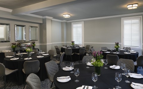event room with multiple round tables all set up for an event
