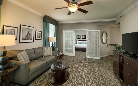 living room area with two double doors leading to a bedroom