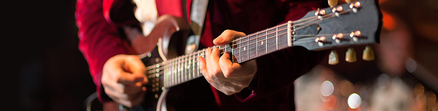 Closeup of man playing a guitar