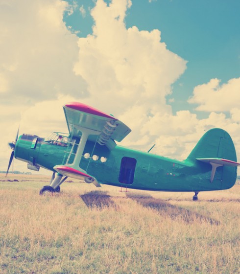 vintage prop plane in field