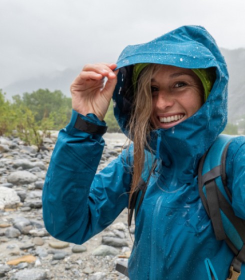woman hiking river rainy day