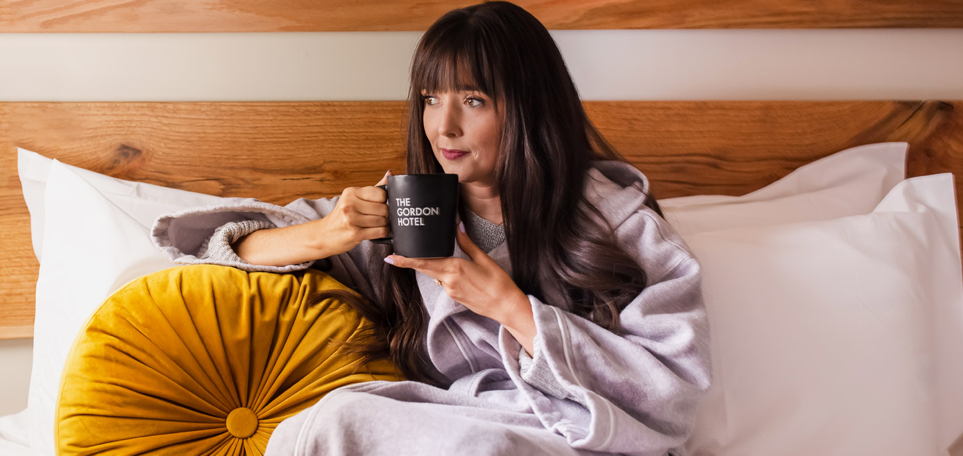 lady in the bed drinking coffee 