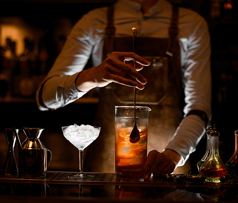 Person stirring cocktail