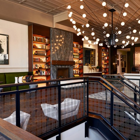 seating area in hotel with lighting fixture hanging from ceiling